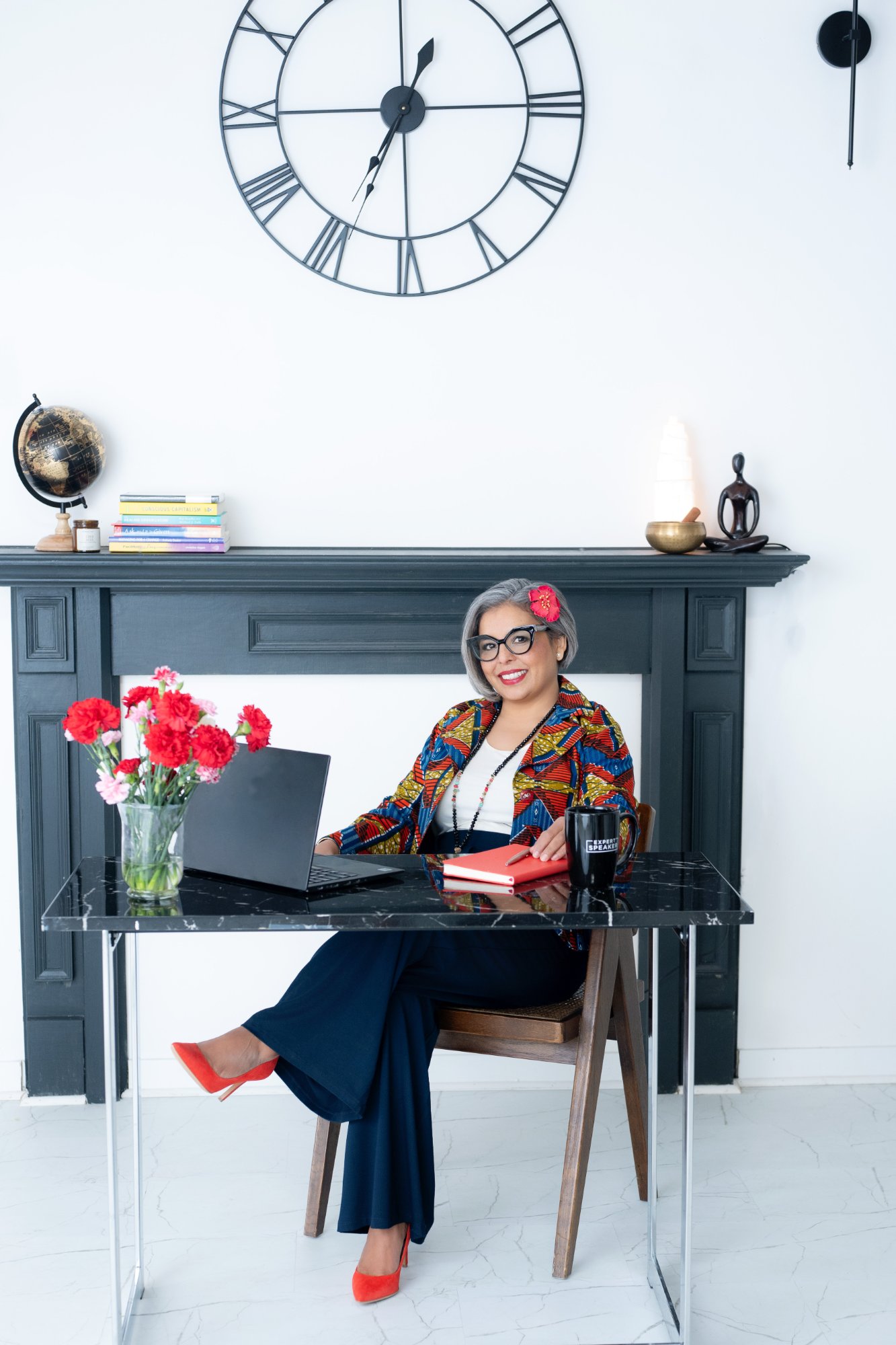 Karen Craggs at desk with clock