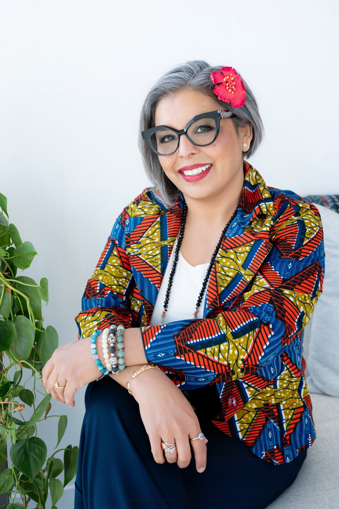 Karen Craggs seated beside plant