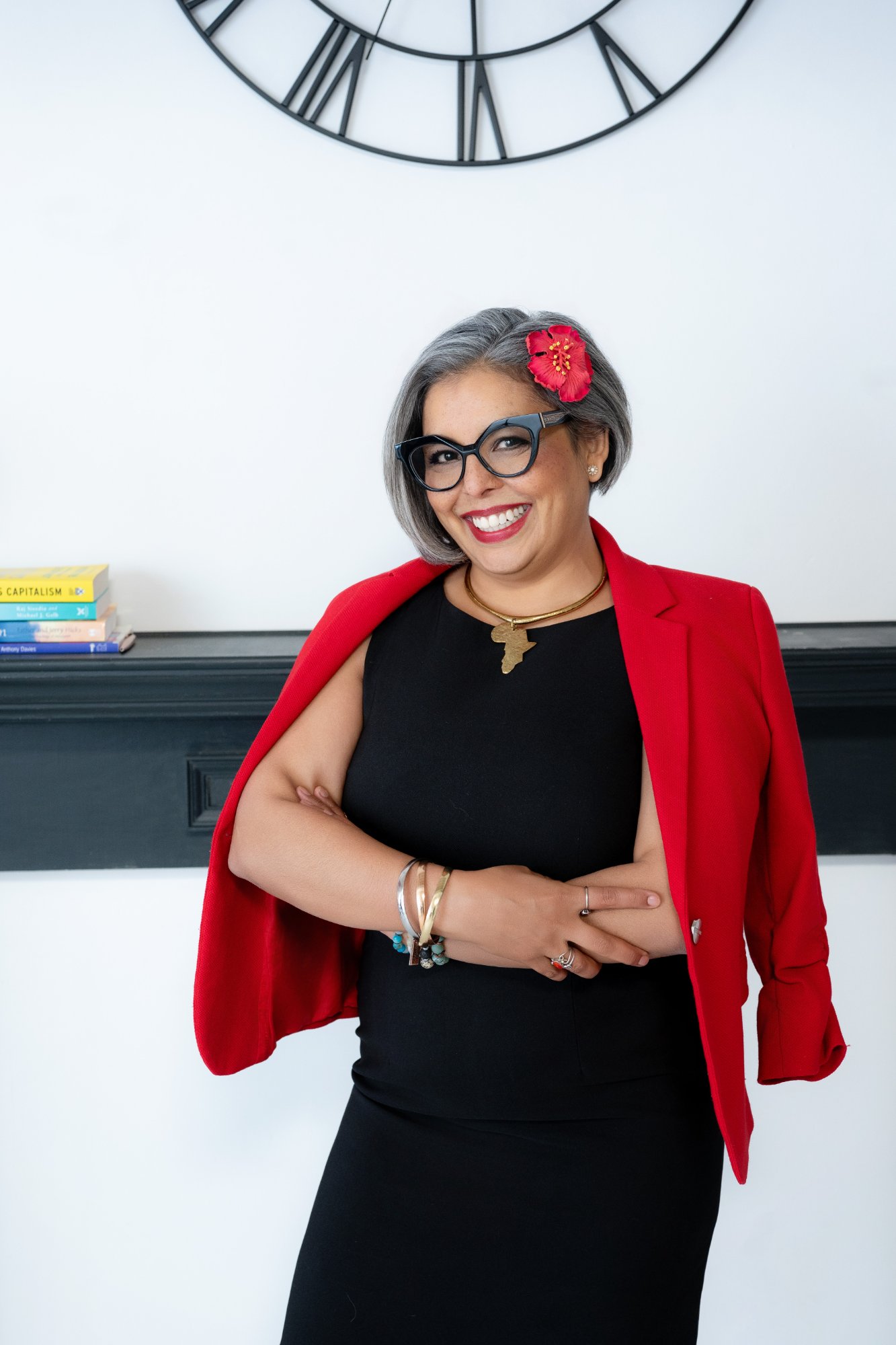 Karen Craggs in red blazer by fireplace