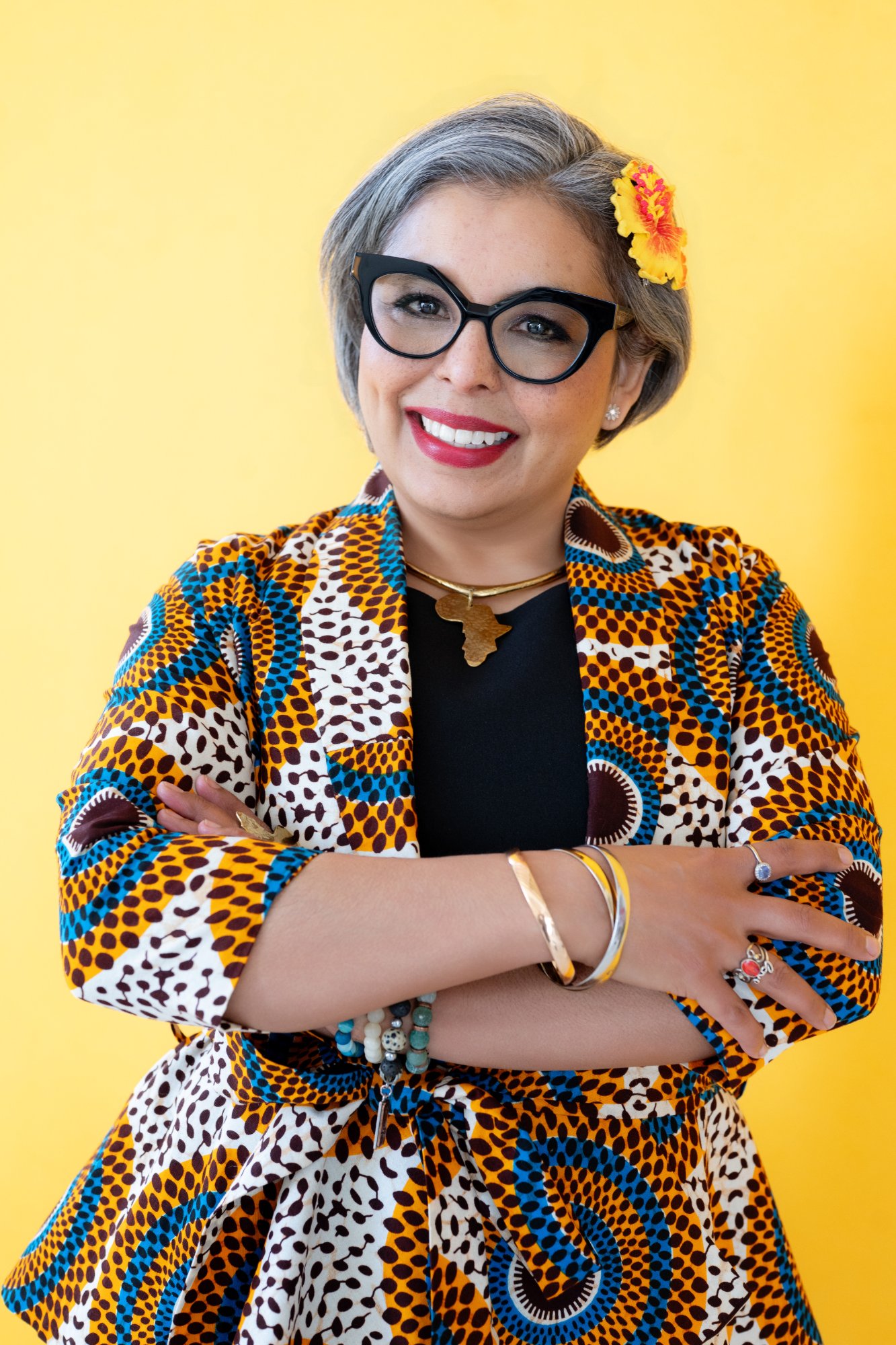 Karen Craggs arms crossed, yellow background